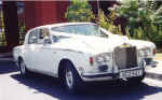 A white wedding rolls royce to arrive in style