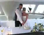 Cutting the wedding cake on board the receptional yaght